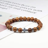 Thompson Luxury Holz-Perlenarmband mit Kreuz “Odi”